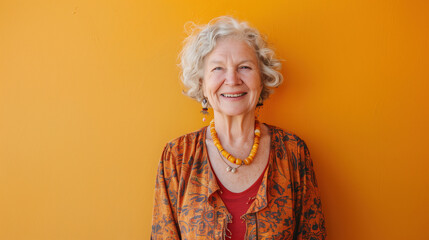 Portrait of happy senior woman isolated on yellow background