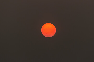 Sunset in the evening sky with clouds and red sun in the evening