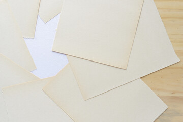 discolored white construction paper sheets with a torn edge 