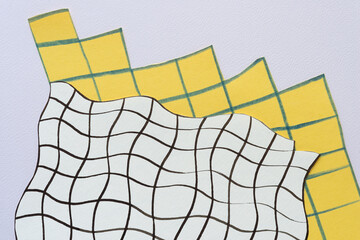 white on yellow paper paper with wavy and geometric line grids on textured, toned paper 