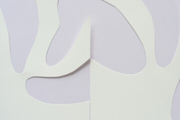abstract paper shapes with rounded or oval shape cutouts on toned paper background with texture
