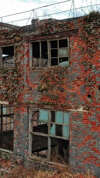 Abandoned ruined industrial factory building, ruins and demolition concept. Aerial view Vertical video