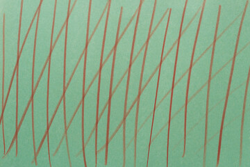 green construction paper with brown color pencil line pattern