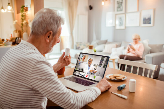 Elderly man consulting with a doctor online in a telehealth appointment