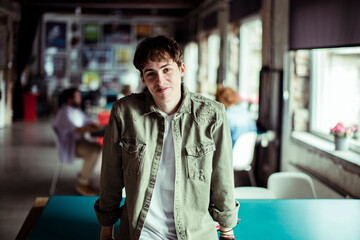Portrait of a confident young man smiling in startup office