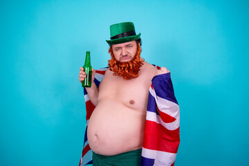 A funny fat man in a leprechaun costume drinks green beer on St. Patrick's Day.