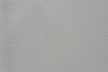 Water drops on white background texture. backdrop glass covered with drops of water. grey bubbles....