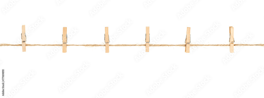 Wall mural wooden clothespins on clothesline isolated white background. household сlothes pins on a jute rope