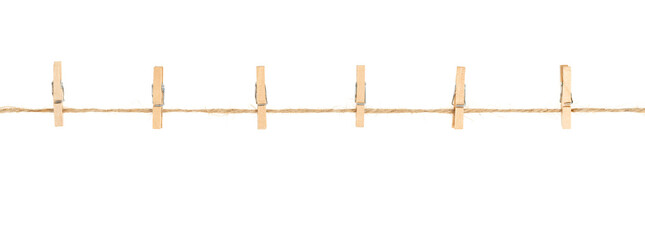 wooden clothespins on clothesline isolated white background. household сlothes pins on a jute rope - obrazy, fototapety, plakaty