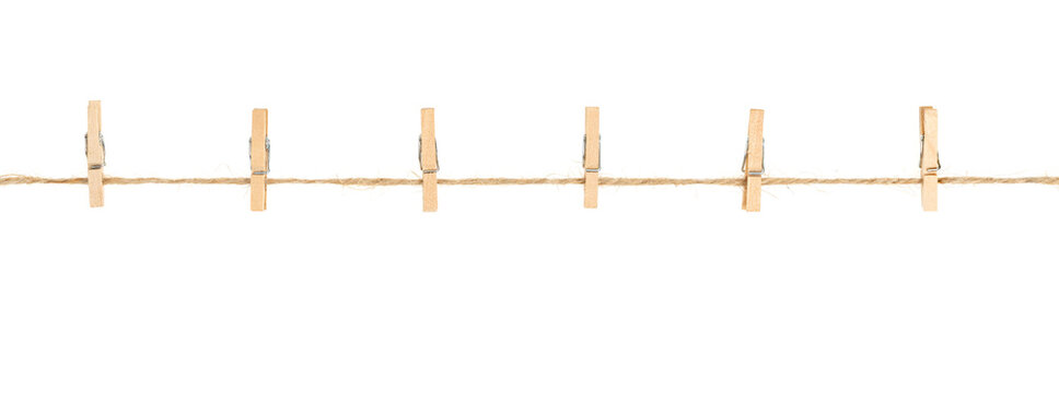 wooden clothespins on clothesline isolated white background. household сlothes pins on a jute rope