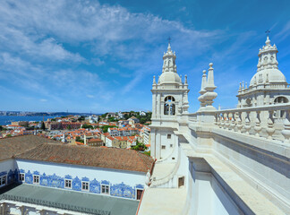 Roof with white bell towers on blue sky background.  Monastery of St. Vincent Outside the Walls, or Church (Iglesia) de Sao Vicente de Fora in Lisbon, Portugal.