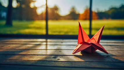 Orgami bird that someone put together, completely red.