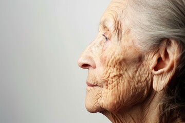 Profile portrait of elderly woman with wrinkled skin Isolated on white background - obrazy, fototapety, plakaty