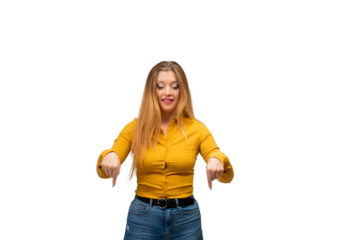 White girl, 30 years old, with long blonde hair, dressed in ocher shirt and jeans, pointing downwards with both hands, on isolated background, for advertising purposes