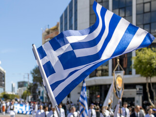 Greek flag fluttering in the wind in front of Greek Independence Day parade in Limassol, Cyprus