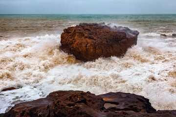 View of the gigantic rocky stone in the stormy Atlantic Ocean in the area of Essaouira in Morocco.