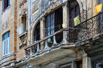 View of one of the old balconies in a building constructed in colonial style on one of the central streets in the historic part of Havana. Cuba.