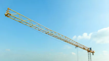 Foto op Canvas Industrial construction crane with blue sky background at building site © Piman Khrutmuang