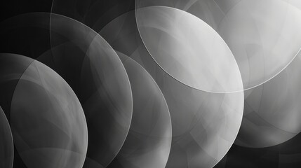 Abstract grayscale image featuring overlapping translucent circles with varying shades of light and shadow, creating a dynamic layered effect.