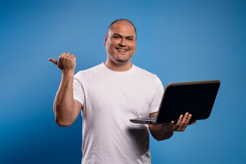 man holding a notebook and pointing to the side