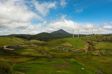 Wind turbines for electric power production on the hills. Wind power plant. Ecological landscape. Ambewela, Sri Lanka. - obrazy, fototapety, plakaty