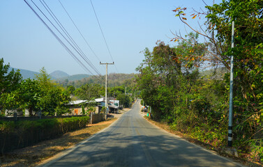 Fototapeta na wymiar Road winding through the Pai River Valley leading to the Huay Pu Keng long-neck Kayan village in the Mae Hong Son province in the northwest of Thailand, close to the Burma border