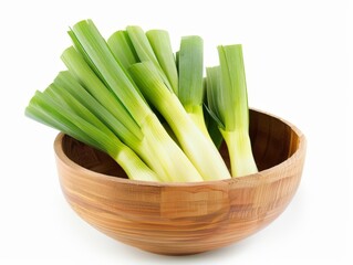 A wooden bowl contains fresh celery stalks, neatly arranged and ready for cooking or snacking