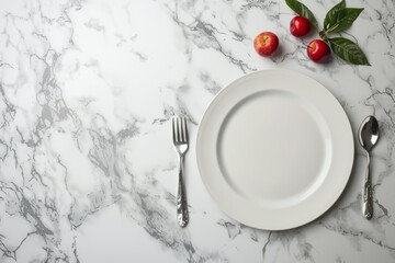 A white plate sits on a marble table, accompanied by a fork and knife. The composition is dynamic, with ample negative space around the objects
