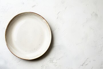 A white plate sits on top of a white table, creating a simple and clean composition with negative space