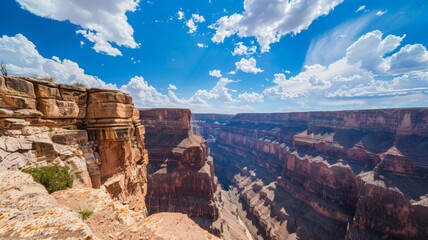 The vast expanse of the Grand Canyon, showcasing its monumental size and intricate rock formations under a clear sky