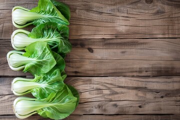 A bunch of lettuce neatly arranged on top of a wooden table