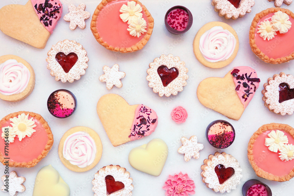 Poster mothers day or love themed baking background with assorted cookies and sweet treats. top view on a w