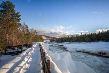 Idyllic winter landscape near the Storforsen, the large rapids on Piteälven in Norrbotten County...