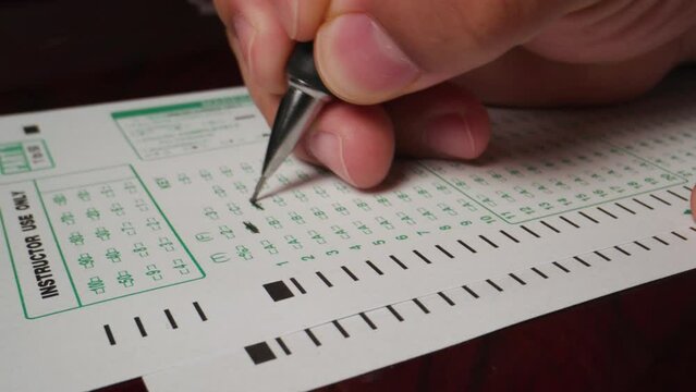 2 hispanic male hand filling out writing exam test form