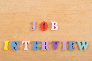 JOP INTERVIEW word on wooden background composed from colorful abc alphabet block wooden letters,...