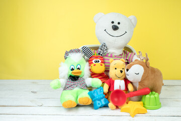 Collection of colorful toys on a yellow background. Kids toys.