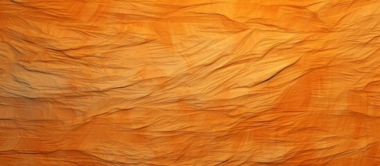 A close up of a crumpled rectangle of brown paper resembling the texture of hardwood flooring. The paper has a mix of amber, orange, and beige tones, giving it a natural wood stain look