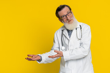 Senior elderly doctor cardiologist man raising hands asking what why reason of failure...