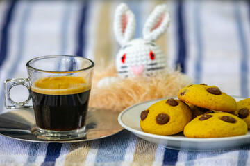 Easter coffee with cookies and easter bunny in selective focus. Easter atmosphere