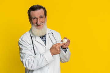 It is your time to heal. Senior elderly doctor cardiologist man showing time on pocket watch clock...