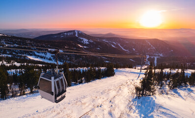 Aerial top view Sheregesh ski lift resort in winter, landscape on mountain with sunset light,...