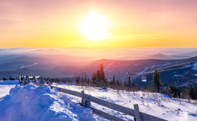 Landscape snowy forest on mountain ski lift resort in winter sunset light, Sheregesh, Kemerovo...