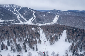 Aerial view drone Sheregesh, Kemerovo, Russia, mountains and forest, winter ski resort.