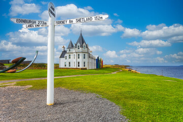 The John O'groats sign during summer sunny day with scattered clouds, Scotland, UK