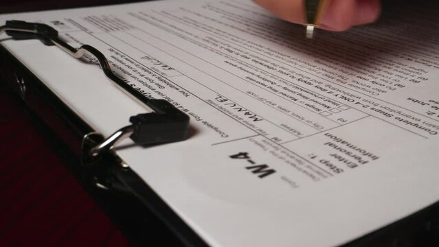 17 hispanic male hand filling out writing w4 irs tax employee form document