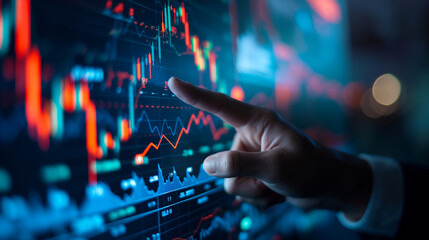 Analyzing Financial Data on Digital Display. Close-up of a hand pointing at financial graphs on a high-tech digital screen, indicative of market analysis and investment strategies. - obrazy, fototapety, plakaty