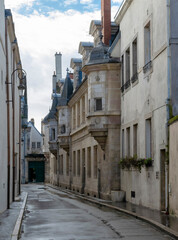 Urban vintage abstract background  featuring dark winter streets and architecture details of Dijon city in France.