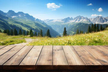 Wooden table top on blur mountain and a meadow with flowers and a path. View of copy space - 771699478