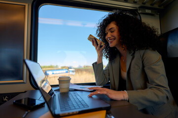 Commuter in casual work attire engrossed in work and leisure on the go.