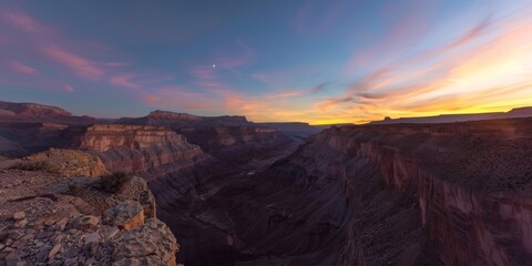 The sun sets over a majestic canyon nestled in the mountains, creating a stunning natural display of colors